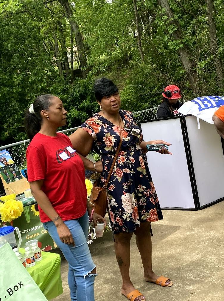 Community members in conversation at a garden event